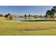 Scenic view of golf course pond, featuring lush green grass and mature trees in a serene setting at 17830 N 45Th Ave, Glendale, AZ 85308