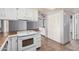 Functional kitchen with white cabinetry, laminate countertops, and modern stove at 17830 N 45Th Ave, Glendale, AZ 85308