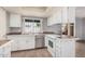 Functional kitchen with white cabinets, laminate countertop and modern appliances at 17830 N 45Th Ave, Glendale, AZ 85308