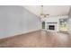 Bright living room featuring tile flooring, a ceiling fan, and a cozy fireplace at 17830 N 45Th Ave, Glendale, AZ 85308