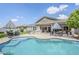 Beautiful backyard featuring a sparkling pool, outdoor kitchen, and shaded patio area at 18066 N Stonegate Rd, Maricopa, AZ 85138