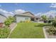 A well-maintained backyard features artificial grass, covered patio, and lush landscaping at 18066 N Stonegate Rd, Maricopa, AZ 85138