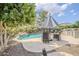 Lush backyard with a sparkling pool, a relaxing water feature, and patio seating area at 18066 N Stonegate Rd, Maricopa, AZ 85138