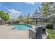 Resort-style pool with lush landscaping, decorative fencing, and shaded seating for ultimate relaxation at 18066 N Stonegate Rd, Maricopa, AZ 85138