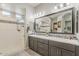 Modern bathroom featuring dual sinks, vanity, walk-in shower, and decorative tile accents at 18066 N Stonegate Rd, Maricopa, AZ 85138