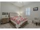 Cozy bedroom with a comfortable bed, side tables, neutral colors, and a window with plantation shutters at 18066 N Stonegate Rd, Maricopa, AZ 85138