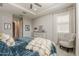 Serene bedroom with tray ceilings, dresser, window views, and cozy armchair seating at 18066 N Stonegate Rd, Maricopa, AZ 85138