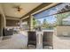 Inviting covered patio with ceiling fan, stylish furniture, and beautiful backyard pool view at 18066 N Stonegate Rd, Maricopa, AZ 85138