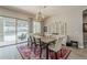 Elegant dining room with sliding glass doors, a stylish chandelier, and neutral color palette at 18066 N Stonegate Rd, Maricopa, AZ 85138