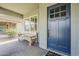 Close-up view of a blue front door with glass windows and a covered porch at 18066 N Stonegate Rd, Maricopa, AZ 85138