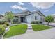 Charming single-story home featuring a lush lawn, walkway, and attached two-car garage at 18066 N Stonegate Rd, Maricopa, AZ 85138