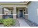 Inviting covered front porch featuring stone accents and a blue front door at 18066 N Stonegate Rd, Maricopa, AZ 85138