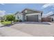 Attached two-car garage with brick paver driveway and manicured landscaping at 18066 N Stonegate Rd, Maricopa, AZ 85138