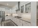 Well-equipped kitchen featuring white cabinets, stylish backsplash, and modern stainless steel appliances at 18066 N Stonegate Rd, Maricopa, AZ 85138