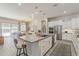 Open concept kitchen with large island, stainless steel appliances, and adjacent dining area at 18066 N Stonegate Rd, Maricopa, AZ 85138