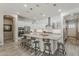 Bright kitchen with white cabinets, large island with seating, and stainless steel appliances at 18066 N Stonegate Rd, Maricopa, AZ 85138