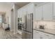 Bright kitchen with stainless steel refrigerator, built-in microwave, and modern finishes at 18066 N Stonegate Rd, Maricopa, AZ 85138