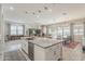 Spacious open-concept floor plan with kitchen island, stainless appliances, dining, and living areas at 18066 N Stonegate Rd, Maricopa, AZ 85138