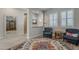 Bright living room with stylish decor, plantation shutters, and wood-look flooring at 18066 N Stonegate Rd, Maricopa, AZ 85138