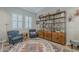 Comfortable living room with plush blue chairs, wood floors, and natural light at 18066 N Stonegate Rd, Maricopa, AZ 85138