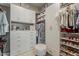 Spacious walk-in closet featuring ample shelving, drawers, and hanging space for optimal storage solutions at 18066 N Stonegate Rd, Maricopa, AZ 85138