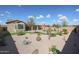 Spacious backyard featuring desert landscaping, artificial turf, and covered patio at 18137 W Deer Creek Rd, Goodyear, AZ 85338