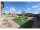 Well-maintained backyard with manicured landscaping and rock accents at 18137 W Deer Creek Rd, Goodyear, AZ 85338