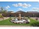 Artistically landscaped backyard featuring water feature and artificial grass at 18137 W Deer Creek Rd, Goodyear, AZ 85338