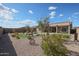 Backyard featuring rock landscaping, artificial turf, and desert plants at 18137 W Deer Creek Rd, Goodyear, AZ 85338