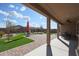 Landscaped backyard with covered patio, artificial turf, and decorative rocks at 18137 W Deer Creek Rd, Goodyear, AZ 85338