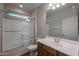 Bathroom features a shower and tub combo, a single sink, and wood-look flooring at 18137 W Deer Creek Rd, Goodyear, AZ 85338
