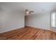 Bright, airy bedroom with wood floors, ceiling fan, and plantation shutters allowing natural light to flow in at 18137 W Deer Creek Rd, Goodyear, AZ 85338