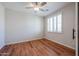 Bright, vacant bedroom features wood-look floors, plantation shutters and a ceiling fan at 18137 W Deer Creek Rd, Goodyear, AZ 85338