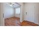 Light-filled bedroom with wood flooring features a ceiling fan and bright white shutters at 18137 W Deer Creek Rd, Goodyear, AZ 85338
