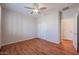 Bright bedroom features wood floors, white walls, and a ceiling fan at 18137 W Deer Creek Rd, Goodyear, AZ 85338