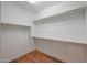 Walk-in closet with wood floor and white walls has sturdy metal shelving for ample storage at 18137 W Deer Creek Rd, Goodyear, AZ 85338