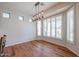 Bright dining room with wood floors, modern lighting, and plantation shutters for a stylish and airy feel at 18137 W Deer Creek Rd, Goodyear, AZ 85338