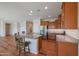 Spacious kitchen island with seating, stainless steel appliances, and rich wood cabinets at 18137 W Deer Creek Rd, Goodyear, AZ 85338