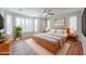 Serene main bedroom featuring plantation shutters, a ceiling fan, and warm wood accents for a cozy retreat at 18137 W Deer Creek Rd, Goodyear, AZ 85338