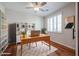 Stylish home office with wood floors, shutters, shelving and a modern wooden desk at 18137 W Deer Creek Rd, Goodyear, AZ 85338