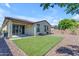 Expansive backyard featuring low maintenance turf, decorative rock, and an overhang at 18362 W Illini St, Goodyear, AZ 85338