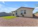 Cozy backyard features synthetic grass, a covered patio with BBQ grill and privacy wall at 18362 W Illini St, Goodyear, AZ 85338