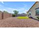 View of backyard highlighting block wall, synthetic grass and landscaping at 18362 W Illini St, Goodyear, AZ 85338