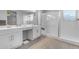 Modern bathroom with double sinks, white cabinets, and a glass enclosed shower at 18362 W Illini St, Goodyear, AZ 85338
