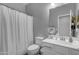 Contemporary bathroom showcasing a toilet, vanity with sink, and a shower behind a curtain at 18362 W Illini St, Goodyear, AZ 85338