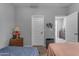 Comfortable bedroom featuring neutral walls, a table lamp, and a view into the hallway at 18362 W Illini St, Goodyear, AZ 85338