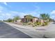 Corner lot home featuring desert landscaping, stone accents and a neutral color palette with a tile roof at 18362 W Illini St, Goodyear, AZ 85338