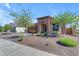 Charming single-story home featuring desert landscaping, a brick driveway, and stone facade accents at 18362 W Illini St, Goodyear, AZ 85338