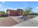 Charming single-story home showcasing a stone facade, a brick driveway, and a well-manicured desert landscape at 18362 W Illini St, Goodyear, AZ 85338