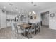 Bright kitchen and dining area featuring a large kitchen island and stainless steel appliances at 18362 W Illini St, Goodyear, AZ 85338
